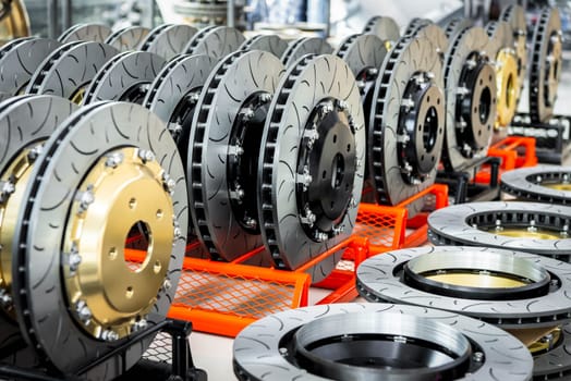 Car mechanic or serviceman disassembly and checking a disc brake and asbestos brake pads for fix and repair problem at car garage or repair shop