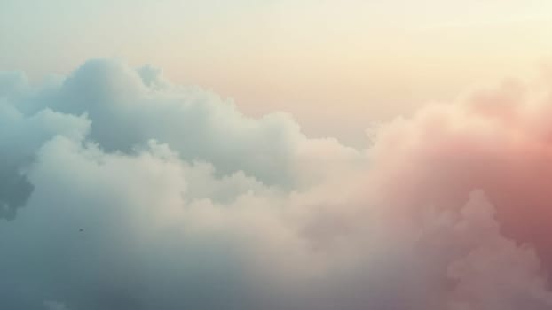 A cloudy sky with a pinkish hue. The sky is filled with clouds and the colors are soft and muted