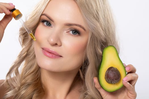 A woman gently applying avocado oil to her face, highlighting the amazing skincare benefits of natural ingredients