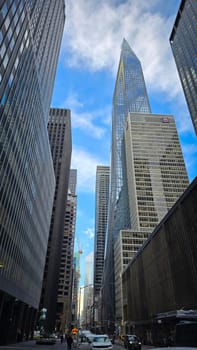 Modern look of a big metropolitan city with illuminated skyscrapers and classic architecture under a clear blue sky. Urban hustle and warm lighting create a vibrant and captivating cityscape. good for multimedia background