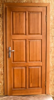 Closed wooden door without people