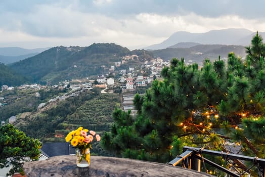 Bouquet of chrysanthemums in a vase under sunset against the backdrop of the mountains Da Lat Vietnam