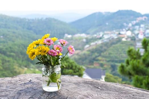 Bouquet of chrysanthemums in a vase under sunset against the backdrop of the mountains Da Lat Vietnam