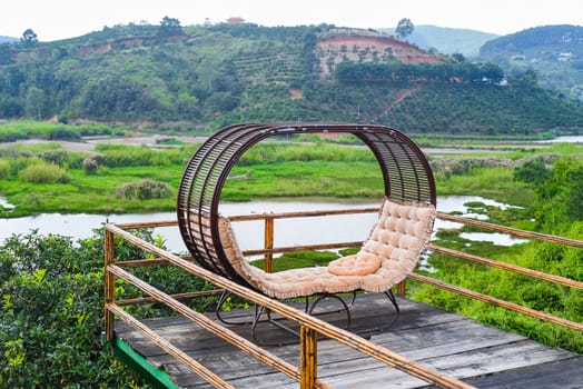 Double bed with cozy pillows against vietnamese landscape of Da Lat city