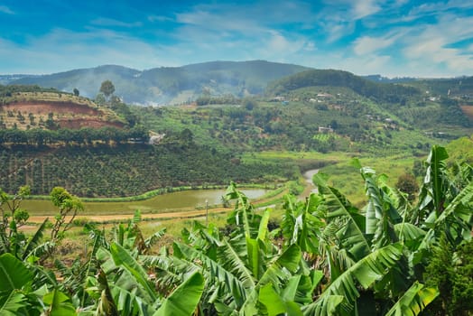 Hills and plantations with steam and clouds of Da Lat city in Vietnam