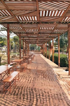 Canopy from the rain with wooden tables and chairs in the city of Da Lat in the mountains of Vietnam