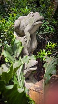 Garden Gnome traditional stone statue situated in a tranquil tropical garden, surrounded by vibrant foliage and artistic decor, harmonizing with the natural beauty of its environment. Good for Background