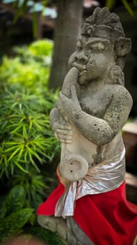 Garden Gnome traditional stone statue situated in a tranquil tropical garden, surrounded by vibrant foliage and artistic decor, harmonizing with the natural beauty of its environment. Good for Background