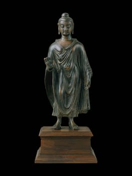Standing Buddha statue from the ancient Gandhara region, late 6th century, showcasing intricate stone craftsmanship and serene meditation pose.