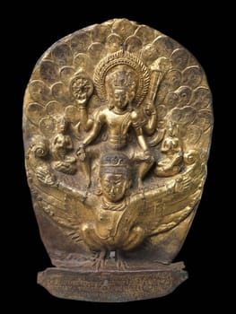 Ancient sculpture from Nepal depicting the Hindu deity Vishnu riding his sacred mount, Garuda, showcasing intricate craftsmanship and religious symbolism.