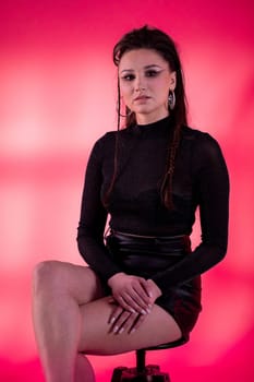 A stunning portrait of a beautiful woman in a chic outfit, posed against a vibrant and colorful background