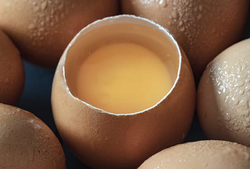 Close-up of Egg yolk in Broken raw chicken eggshell and Fresh chicken egg (Hen egg). Natural organic fresh eggs for healthy food, use it as your Space for text, Design, Wallpaper and Poster, Selective focus.