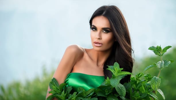 pretty elegant young woman in green dress with peppermint, AI generated image