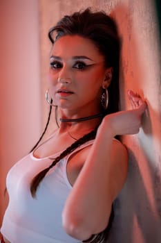 A striking portrait of a young woman exuding confidence and style, illuminated by colorful lighting.