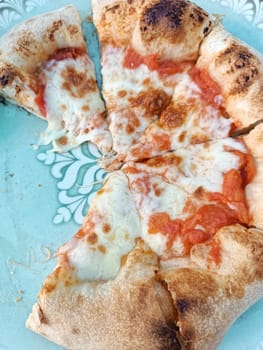 neapolitan homemade pizza margarita from the brick oven. Italian Pizza on blue plate true Traditional Margherita. High quality photo
