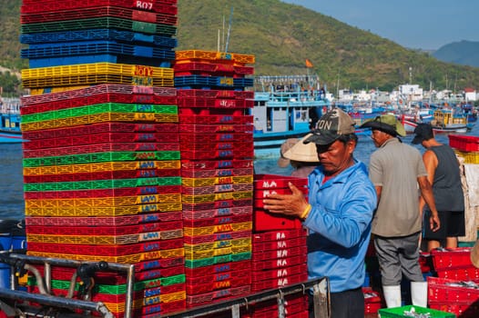 Asian fishermen unload their catch at the fishing port in Nha Trang. Vietnam, Nha Trang - September 8, 2024