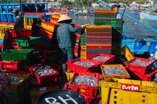 Asian sellers unload and sell fresh fish at the fish market. Vietnam, Nha Trang - September 8, 2024