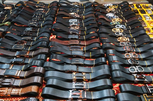 Genuine leather men's belts on the counter in the Asian market. Da Nang, Vietnam - November 29, 2024