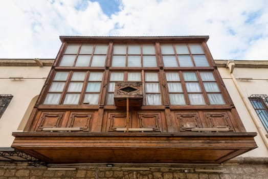 Amidst the winding streets of Icherisheher, traditional wooden balconies showcase the rich cultural heritage of Baku, Azerbaijan. The intricate details of this historic architecture are captivating
