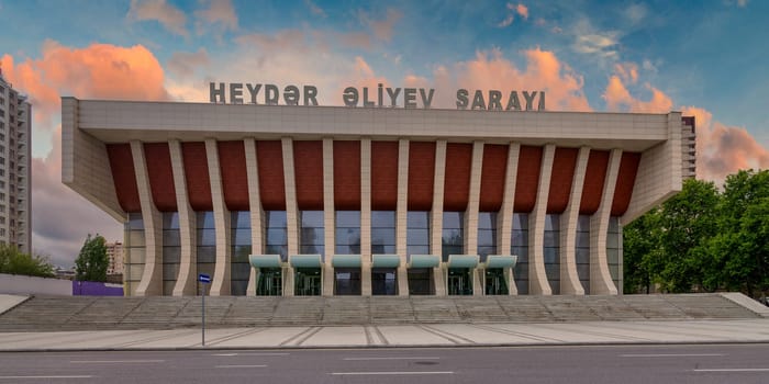 The Heydar Aliyev Palace in Baku, Azerbaijan combines Soviet modernist and Azerbaijani architectural styles, embodying the city's rich cultural heritage through its imposing facade and grand staircase