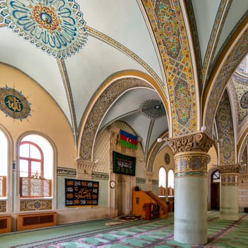 Baku, Azerbaijan - May 10, 2024: The interior of Icherisheher Juma Mosque in the Old, is adorned with intricate details, including magnificent arches and vibrant artistic motifs