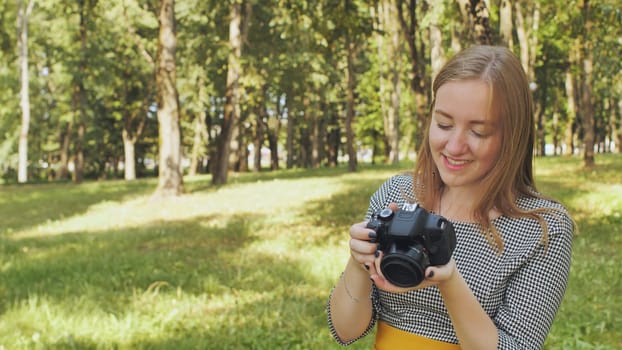 Professional female photographer reviewing recent images, beaming with satisfaction in lush green park setting