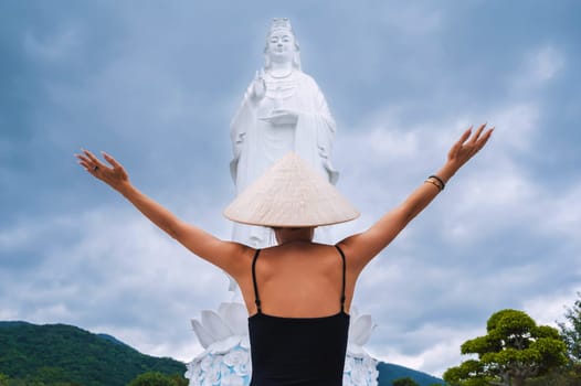 woman tourist traveler at Lady Buddha statue at the Linh Ung Pagoda in Da Nang in Vietnam. The concept of travel and tourism in Asia