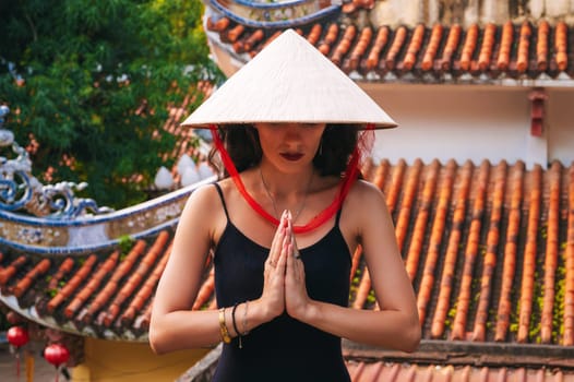 portrait of a woman tourist traveler at the temple on the Buddhist pagoda in Vietnam. Travel and tourism in Asia