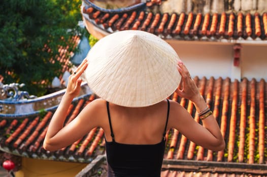 back of a woman tourist traveler at the temple on the Buddhist pagoda in Da Nang in Vietnam. Travel and tourism in Asia