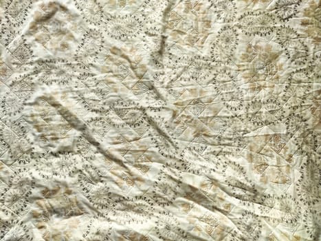 Soft, textured fabric features a delicate pattern ideal for creative projects requiring a customizable background or decorative element.
