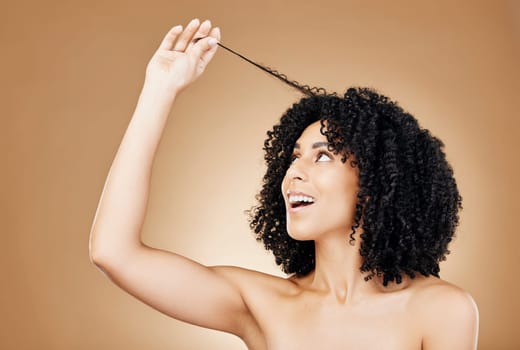 Hair, curls and growth with woman and beauty, shine and salon treatment with natural cosmetics on brown background. Wellness, haircare and texture with happy model, studio with curly afro hairstyle.