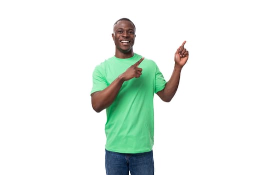 young confident american man dressed in green t-shirt with textile print mockup.