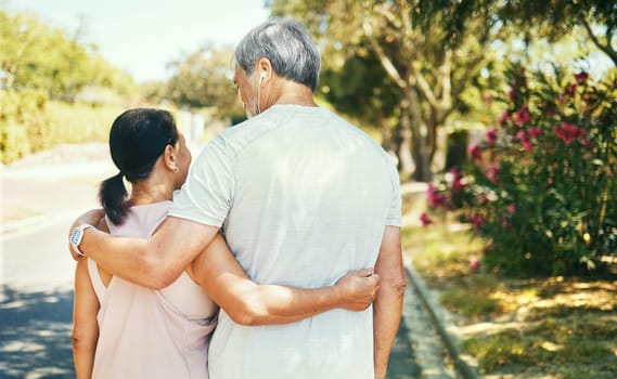 Back, hug and a senior couple on a walk for bonding, love and exercise in the morning. Happy, relax and an elderly man and woman in the street together for romance in retirement or a marriage.