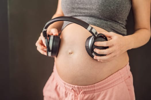 Melodies in the womb: Headphones placed on a pregnant belly, bonding through music, a heartwarming connection between mother and baby.