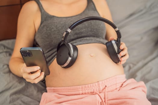 Melodies in the womb: Headphones placed on a pregnant belly, bonding through music, a heartwarming connection between mother and baby.