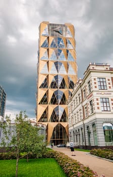 The striking geometric design of a modern skyscraper juxtaposes with traditional architecture in yekaterinburg, russia, creating a captivating urban landscape