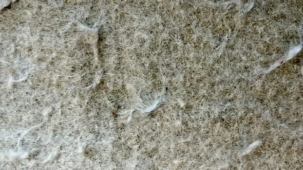 Close-up view of a synthetic fiber surface with a unique texture highlighting its detailed composition.