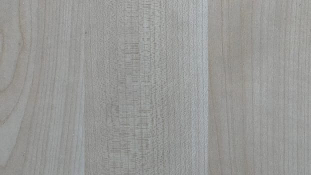 A close view of a light-colored wooden surface showcasing unique grain patterns.
