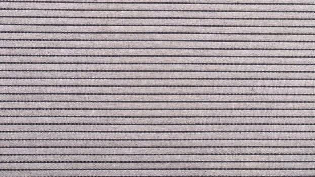 Fabric displays an even pattern of thin, alternating stripes in neutral tones, perfect for various uses.
