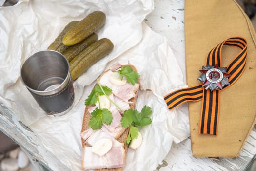 shot of vodka and snack of lard and pickled cucumber,Russians celebrate February 23,Defender of Fatherland Day,May 9,Victory Day,grandfather's awards,St.George ribbon,Order of the Great Patriotic War,