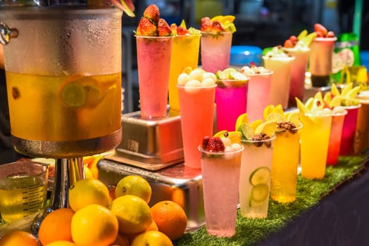 Many smoothie and drinks in plastic cups in Jalan Alor street food in the Kuala Lumpur market