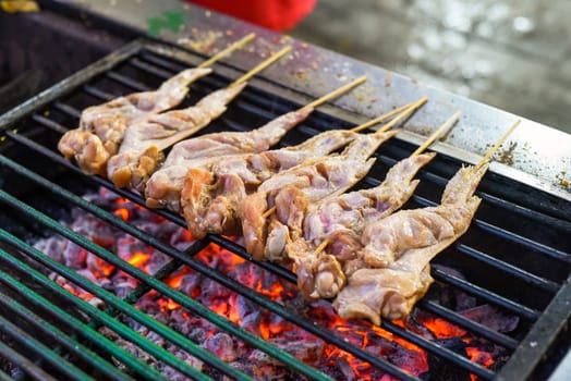 Raw chicken wings for bbq on grill in Jalan Alor street food in Kuala Lumpur