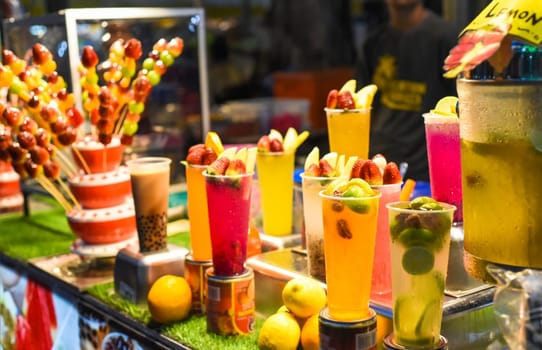 Many smoothie and drinks in plastic cups in Jalan Alor street food in the Kuala Lumpur market