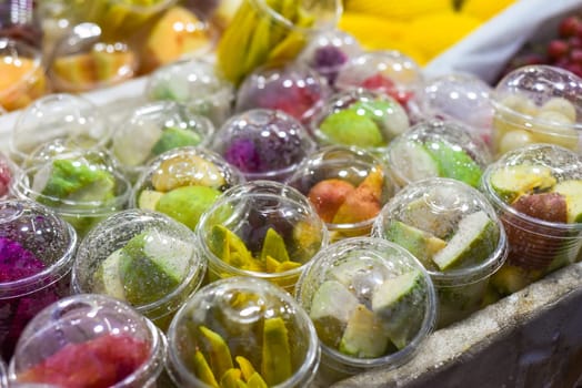 A lot of different pilled fruits in the Jalan Alor street food of Kuala Lumpur market