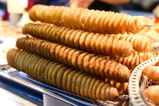 Twisted potatoes in the night market of street food Jalan Alor in Malaysia