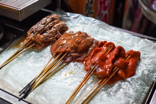 Marinated raw meat on the sticks prepared for bbq in the Jalan Alor street food in Kuala Lumpur, Malaysia