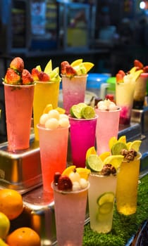 Many smoothie and drinks in plastic cups in Jalan Alor street food in the Kuala Lumpur market