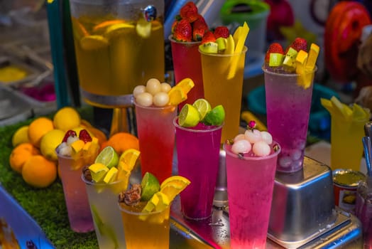 Many smoothie and drinks in plastic cups in Jalan Alor street food in the Kuala Lumpur market