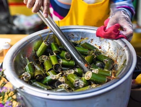 stewed snails with vegetables and lemongrass in bamboo in vietnamese night market
