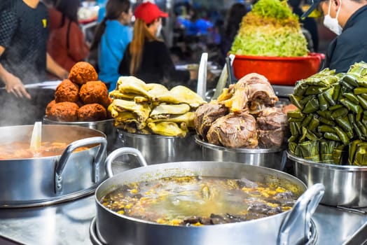 Many vietnamese snacks with boild and fried meat and soup in vietnamese night market in Da Lat